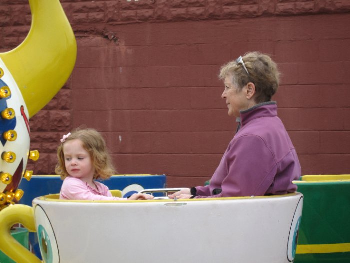 Grammy and Amber take the teacups for a spin